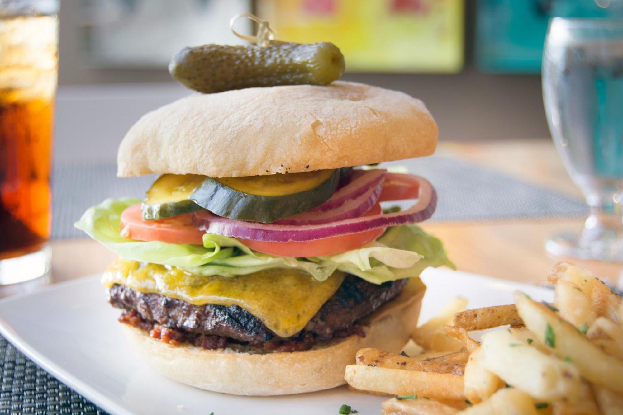 Hotel Murano Tacoma Luaran gambar A cheeseburger with lettuce, tomato, onion, and pickle